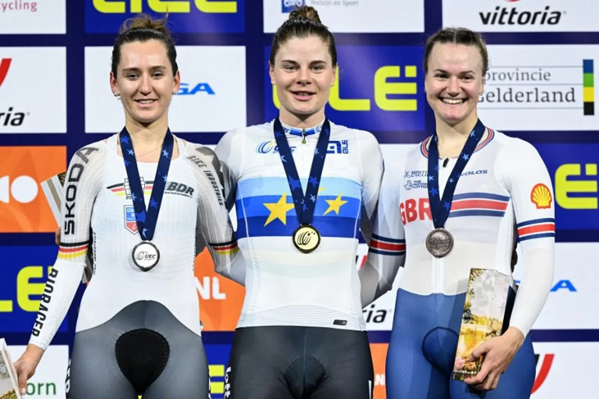 Second placed Germany's Lea Lin Teutenberg (L), First placed Belgium's Lotte Kopecky and Third placed Britain's Jessica Roberts celebrate with medals on the podium for the Women's Elimination race during the fourth day of the UEC European Track Cycling Championships at the Omnisport indoor arena in Apeldoorn, on January 13, 2024.  JOHN THYS / AFP