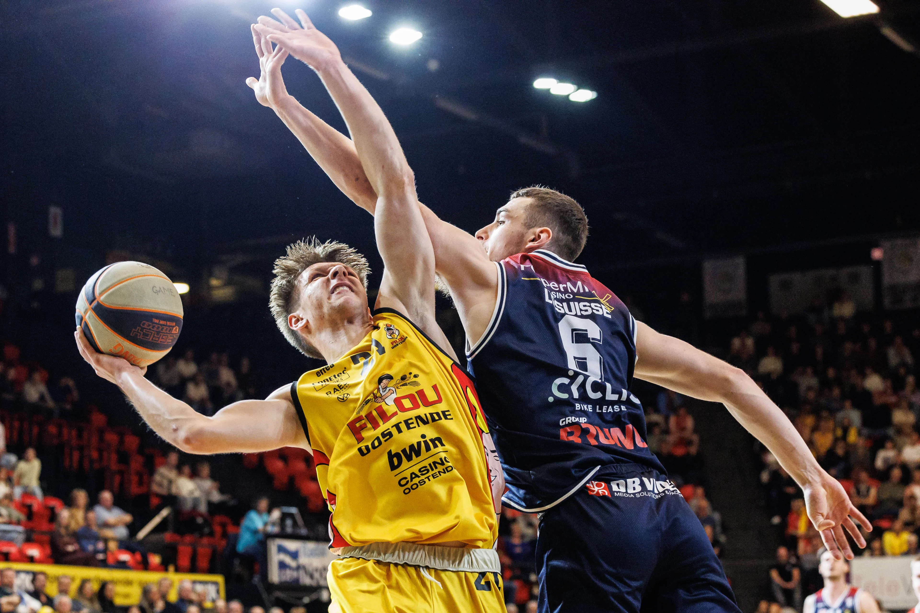 Oostende's Noah Meeusen and Limburg's Jarne Lesuisse fight for the ball during a basketball match between BC Oostende and Limburg United, Saturday 16 November 2024, in Oostende, on day 11 of the 'BNXT League' first division basket championship. BELGA PHOTO KURT DESPLENTER