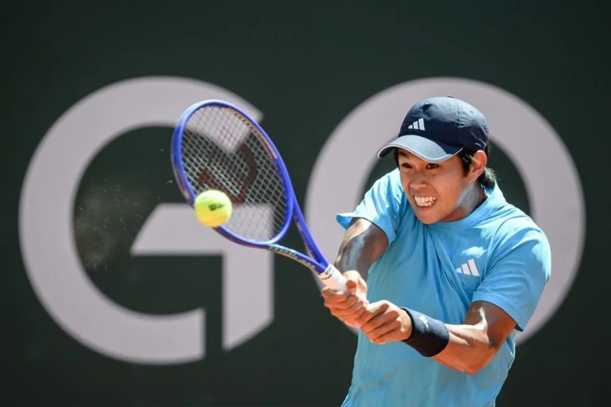 USA's Learner Tien returns a ball to Argentine's Mariano Navone during their men's singles final tennis match at the ATP 250 Geneva Open tennis tournament in Geneva on May 23, 2026. Fabrice COFFRINI / AFP
