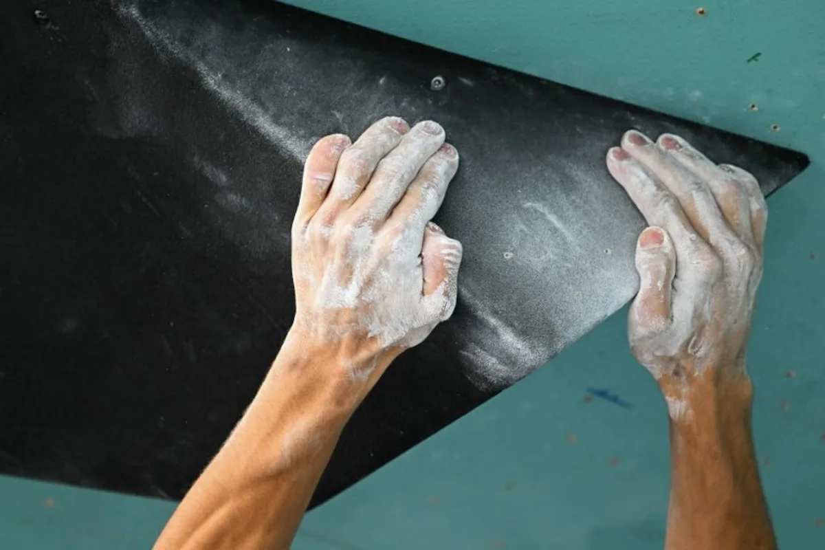 A picture shows the hands of French Paul Jenft while competing in the men's sport climbing boulder final during the Paris 2024 Olympic Games at Le Bourget Sport Climbing Venue in Le Bourget on August 9, 2024.  Fabrice COFFRINI / AFP