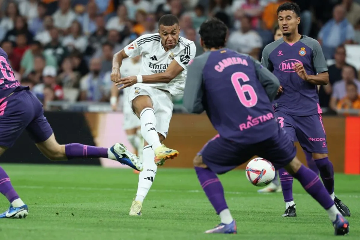 Real Madrid's French forward #09 Kylian Mbappe shoots next to Espanyol's Spanish-Moroccan defender #23 Omar El Hilali (R) during the Spanish league football match between Real Madrid CF and RCD Espanyol at the Santiago Bernabeu stadium in Madrid, on September 21, 2024.  Thomas COEX / AFP