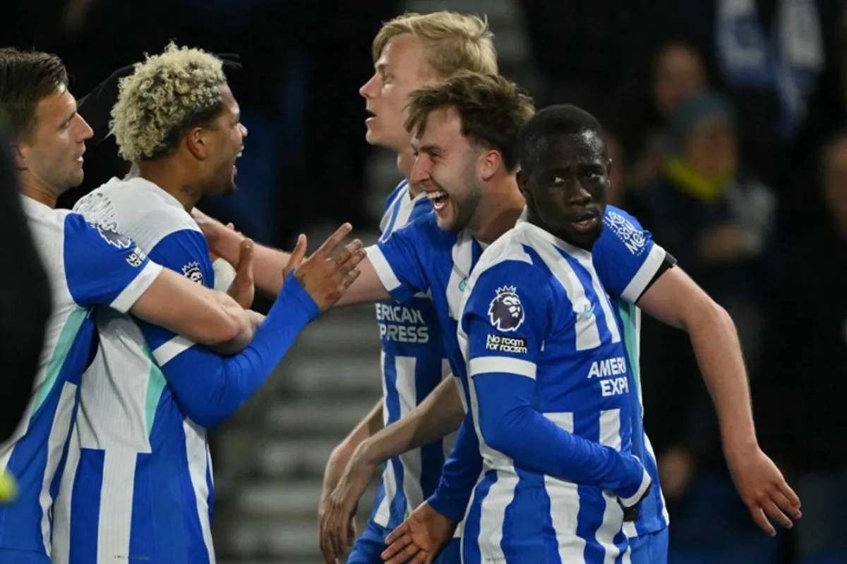 Brighton's English midfielder #13 Jack Hinshelwood (2R) celebrates with teammates after scoring their second goal during the English Premier League football match between Brighton and Hove Albion and Chelsea at the American Express Community Stadium in Brighton, southern England on April 21, 2026.  Glyn KIRK / AFP