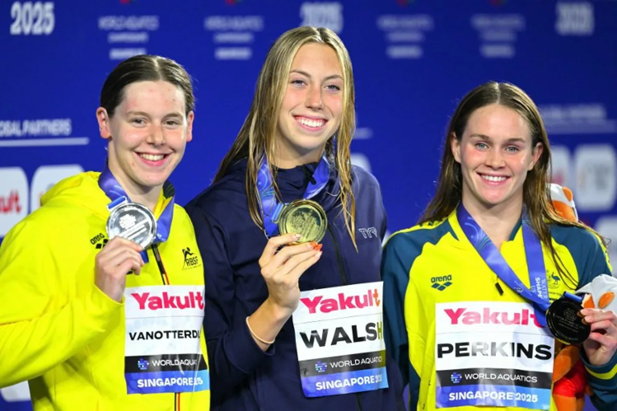 Gold medallist US' swimmer Gretchen Walsh (C), silver medallist Belgium's swimmer Roos Vanotterdijk (L) and bronze medallist Australia's swimmer Alexandria Perkins (R) pose on the podium of the women's 100m butterfly swimming event during the 2025 World Aquatics Championships in Singapore on July 28, 2025. François-Xavier MARIT / AFP