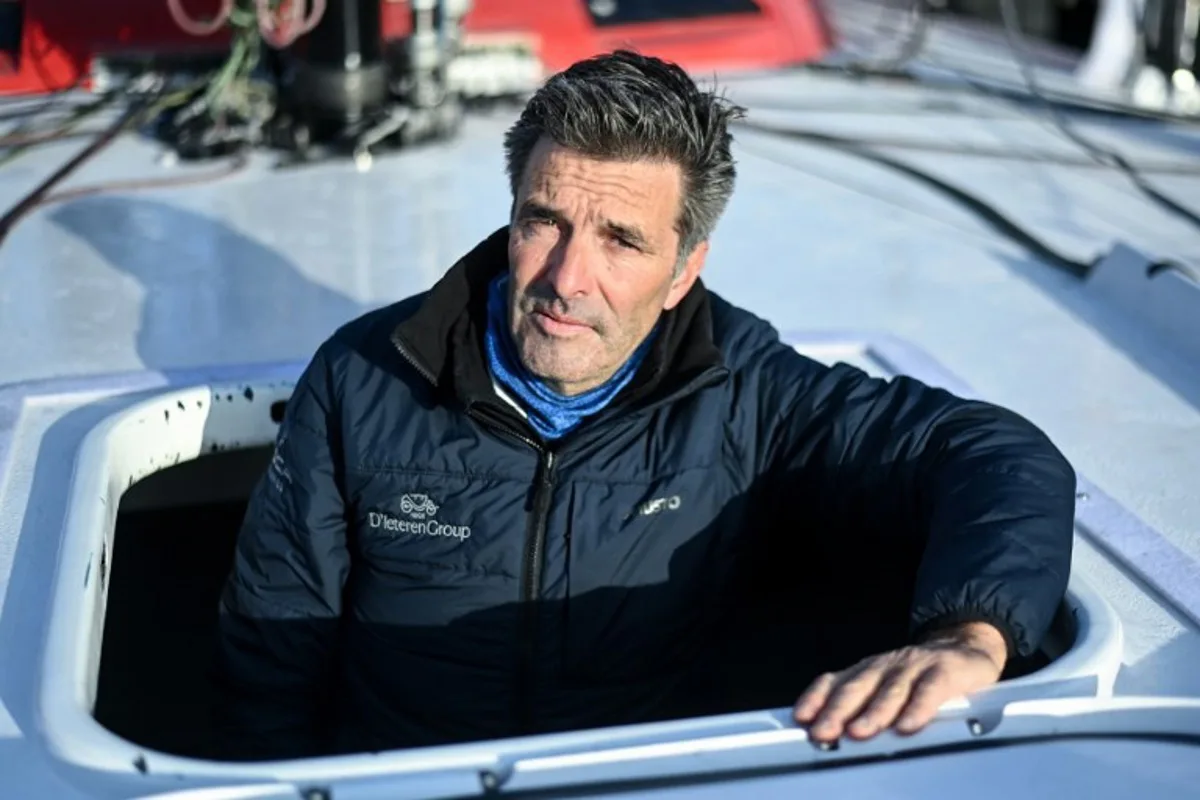 Belgian skipper Denis Van Weynbergh poses aboard his Imoca monohull "D'ieteren Group" ahead of the 10th edition of the Vendee Globe around the world monohull solo sailing race, at the Vendee Globe village in Les Sables-d'Olonne, western France on November 5, 2024.   Sebastien Salom-Gomis / AFP