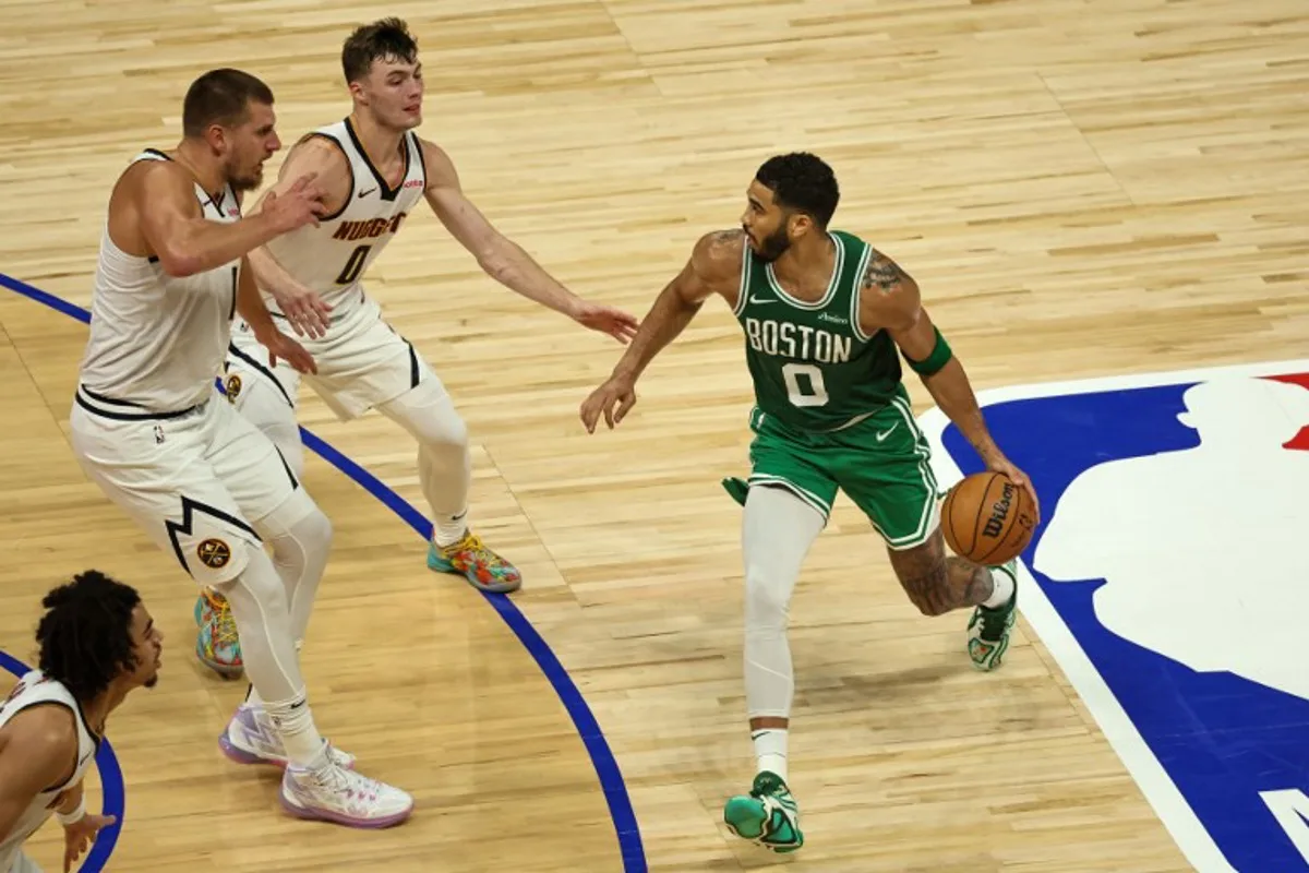 Boston Celtics' forward #0 Jayson Tatum looks to pass during the NBA Preseason game between the Boston Celtics and the Denver Nuggets at the Etihad Arena in Abu Dhabi on October 6, 2024.  Fadel Senna / AFP