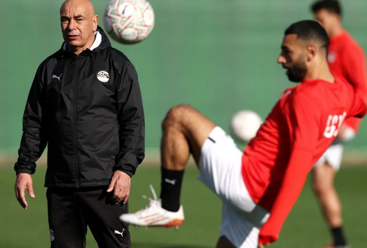 Egypt's head coach Hossam Hassan (L) and Egypt's forward #10 Mohamed Salah attend a training session at the Stadium in Taghzout, Morocco, on December 25, 2025, on the eve of the 2025 Africa Cup of Nations (CAN) football match between Egypt and South Africa.  FRANCK FIFE / AFP
