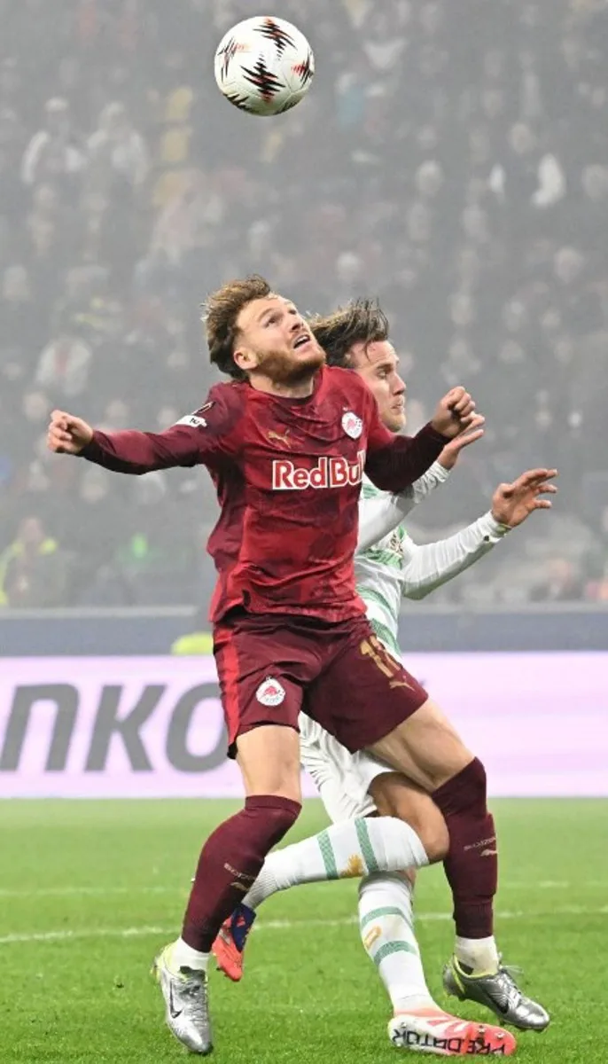 Salzburg's Belgian forward #11 Yorbe Vertessen (L) and Go Ahead Eagles' Dutch midfielder #21 Melle Meulensteen vie for the ball during the UEFA Europa League football match between FC Salzburg and Go Ahead Eagles in Salzburg, Austria on November 6, 2025. BARBARA GINDL / APA / AFP