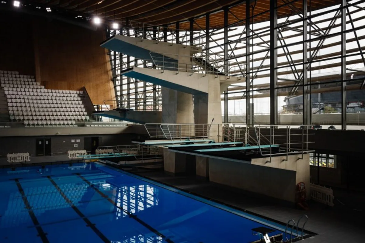 This photograph taken on March 28, 2024 shows diving boards, next to a swimming pool, in the Aquatics Centre built for the Paris 2024 Olympic Games to be used for artistic swimming, diving and water polo competitions in Saint Denis, near Paris. Dimitar DILKOFF / AFP