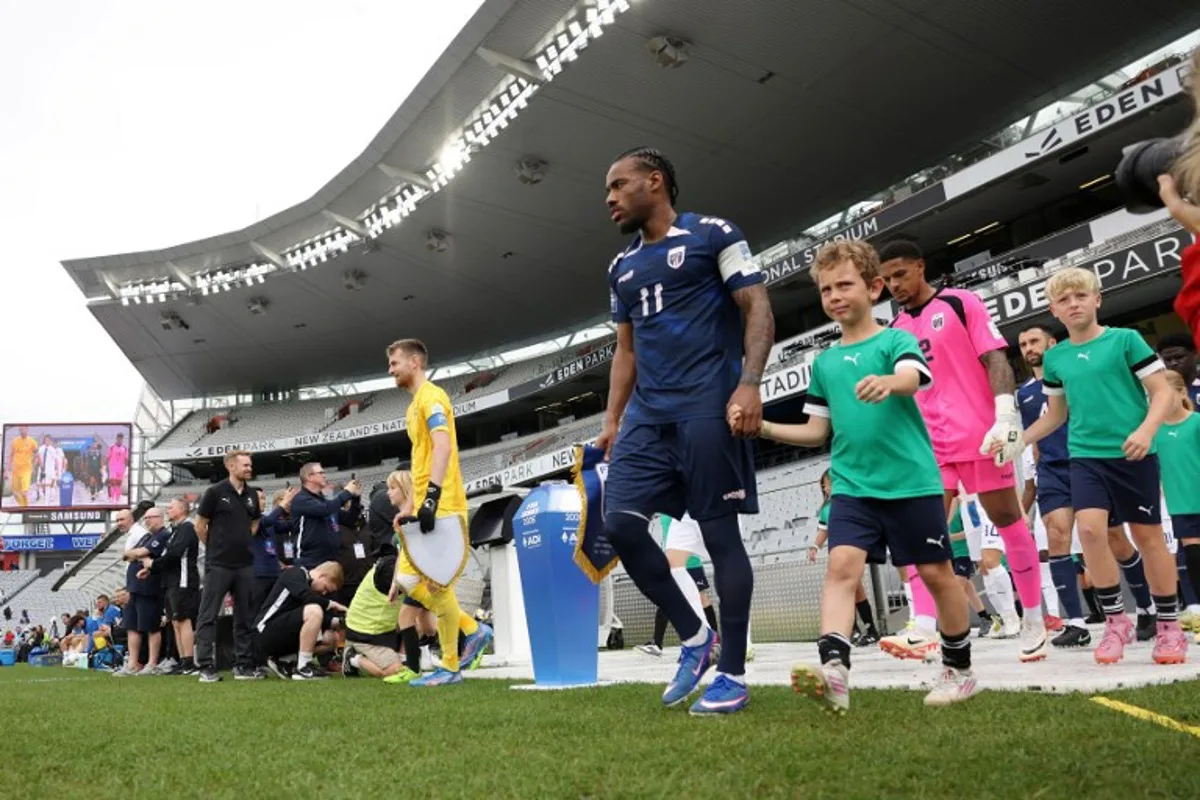 Cape Verde's Garry Rodrigues (R) leads his team out during the international friendly football match between Cape Verde and Finland at Eden Park in Auckland on March 30, 2026.  Michael Bradley / AFP