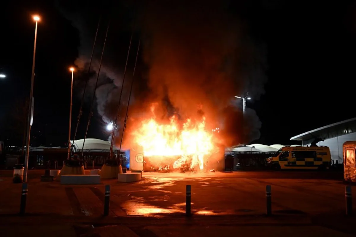 Flames engulf a merchandise stall outside of the Etihad Stadium in Manchester, north west England, on January 29, 2025, ahead of the UEFA Champions League football match between Manchester City and Club Brugge.   Paul ELLIS / AFP