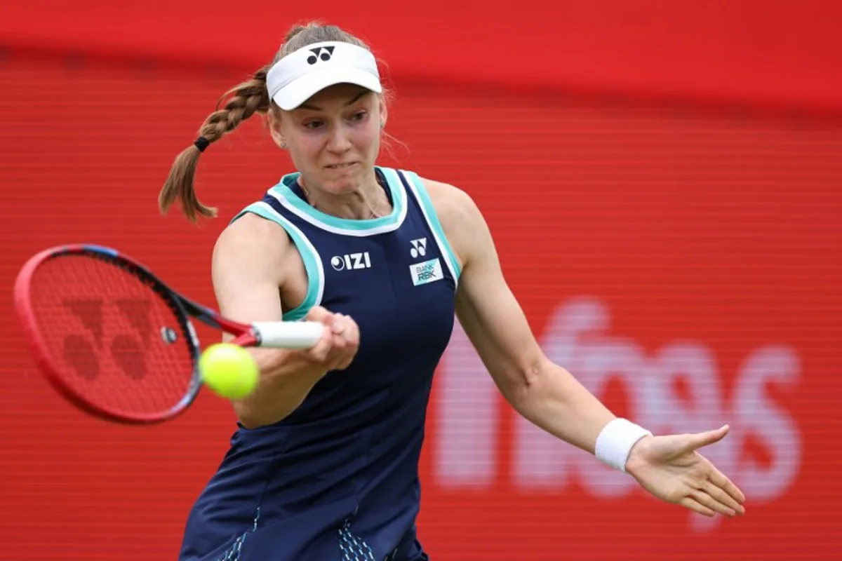 Kazakhstan's Elena Rybakina returns the ball during her round of 16 women's singles match against Germany's Tatjana Maria at the HSBC WTA tennis Championships at Queen's Club in west London on June 12, 2026. Adrian Dennis / AFP