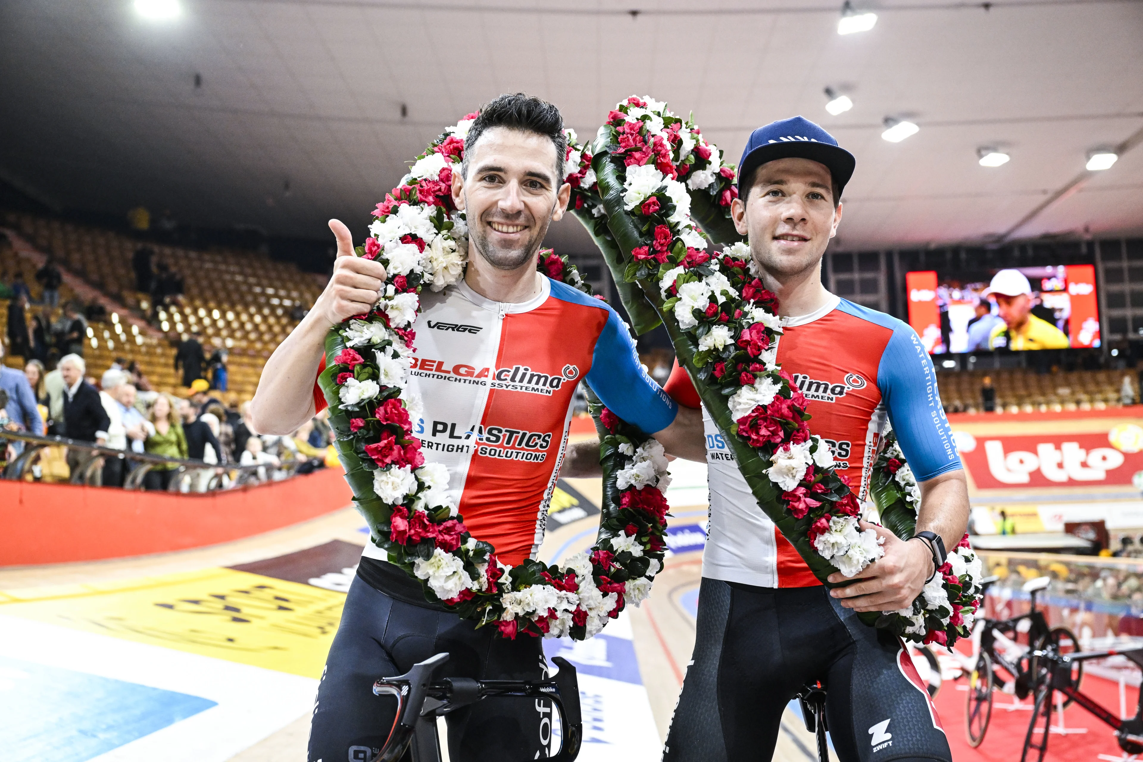 French Benjamin Thomas and Belgian Fabio Van Den Bossche celebrate after winning the sixth and last day of the Zesdaagse Vlaanderen-Gent six-day indoor track cycling event at the indoor cycling arena 't Kuipke, Sunday 17 November 2024, in Gent. BELGA PHOTO TOM GOYVAERTS