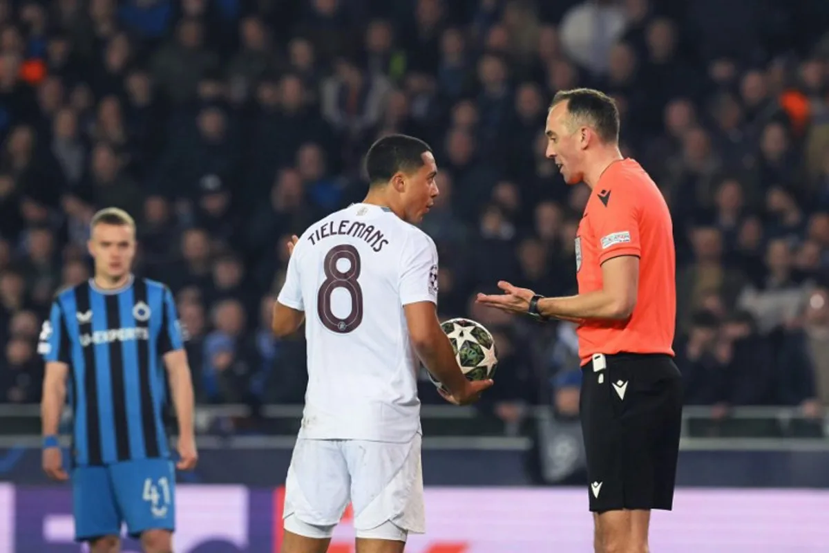Aston Villa's Belgian midfielder #08 Youri Tielemans (C) speaks with Portuguese referee Joao Pinheiro (R) during the UEFA Champions League round of 16 first leg football match between Club Brugge KV and Aston Villa FC at the Jan Breydel Stadium in Bruges, on March 4, 2025. NICOLAS TUCAT / AFP
