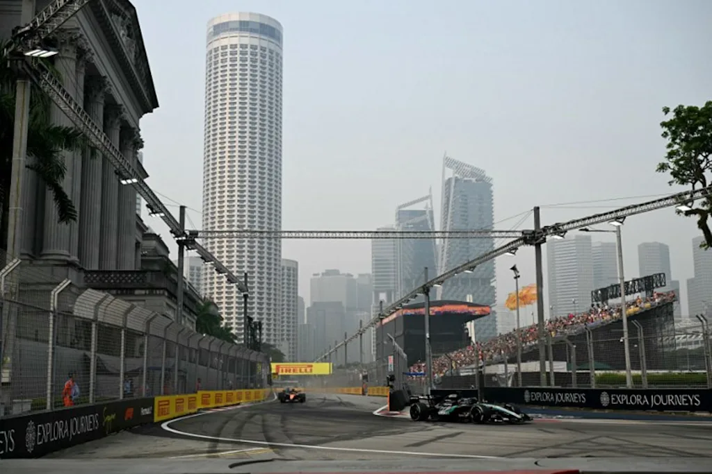Mercedes' British driver George Russell (R) drives during a practice session ahead of the Formula One Singapore Grand Prix at the Marina Bay Street Circuit in Singapore on October 9, 2026. Roslan RAHMAN / AFP