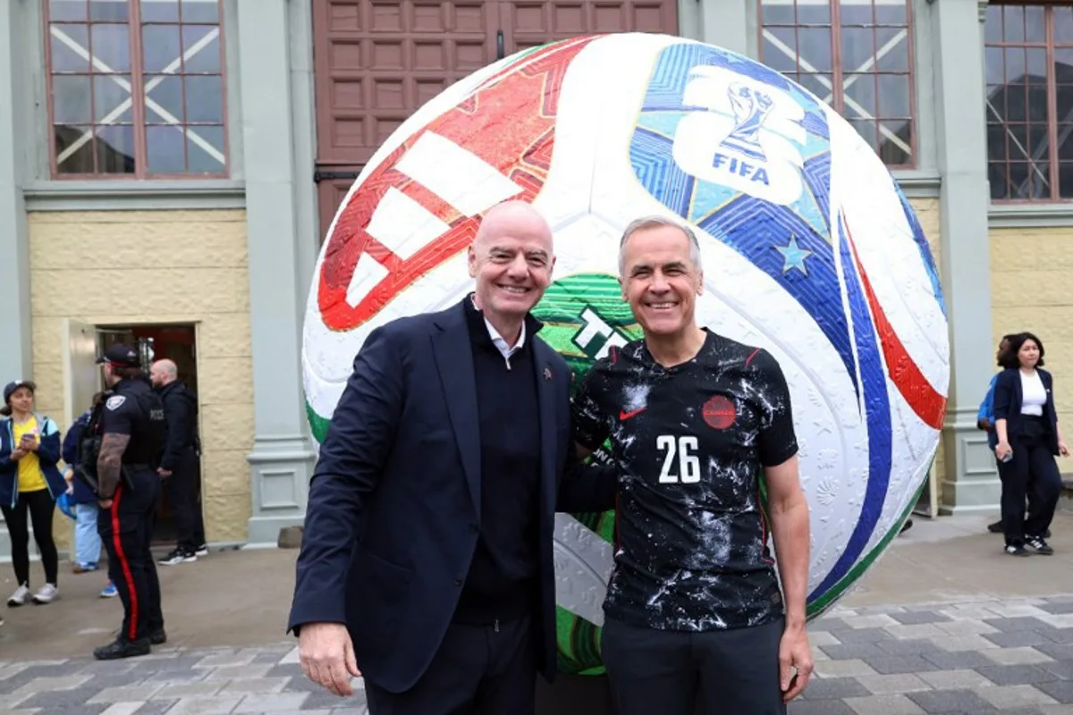 Canada's Prime Minister Mark Carney (R) and FIFA President Giovanni Infantino pose during the FIFA & Coca Cola World Cup Trophy Tour at Park Landsdowne Stadium in Ottawa, Canada, on May 24, 2026. Dave Chan / AFP