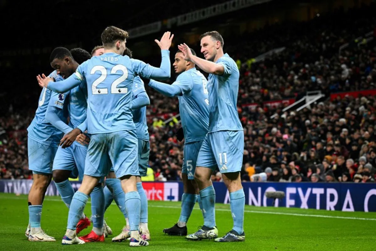 Nottingham Forest's New Zealand striker #11 Chris Wood (C) celebrates with teammates after scoring his team third goal during the English Premier League football match between Manchester United and Nottingham Forest at Old Trafford in Manchester, north west England, on December 7, 2024.  Oli SCARFF / AFP