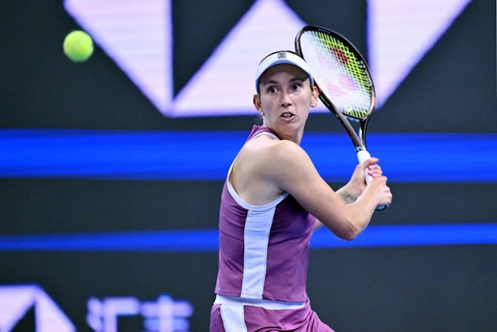 Belgium's Elise Martens hits a return to China's Zheng Qinwen during their women's singles semi-final at the China Open tennis tournament in Beijing on October 10, 2026.  Adek BERRY / AFP