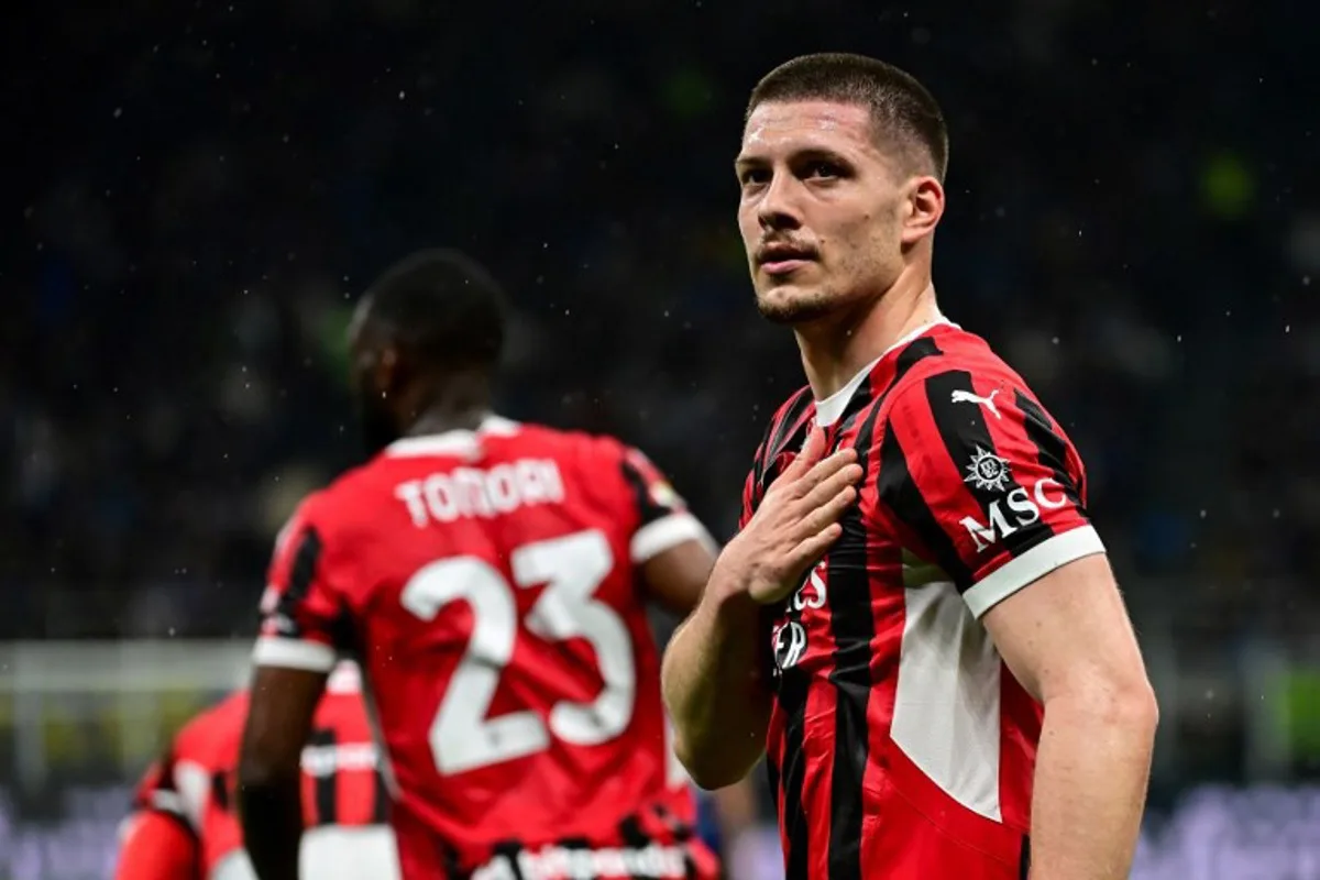 AC Milan's Serbian forward #09 Luka Jovic (R) celebrates after scoring AC Milan's first goal during the Coppa Italia second leg semi-final football match between Inter Milan and AC Milan at the San Siro stadium in Milan on April 23, 2025. Piero CRUCIATTI / AFP