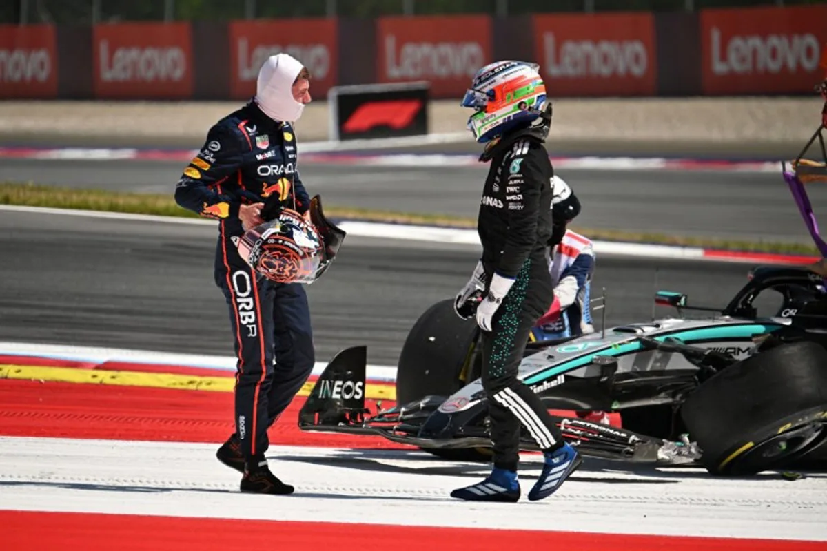 Red Bull's Dutch driver Max Verstappen (L) and Mercedes' Italian driver Kimi Antonelli speak after their cars crashed during the Formula One Austrian Grand Prix at the Red Bull Ring race track in Spielberg, Austria, on June 29, 2025. Jure Makovec / AFP