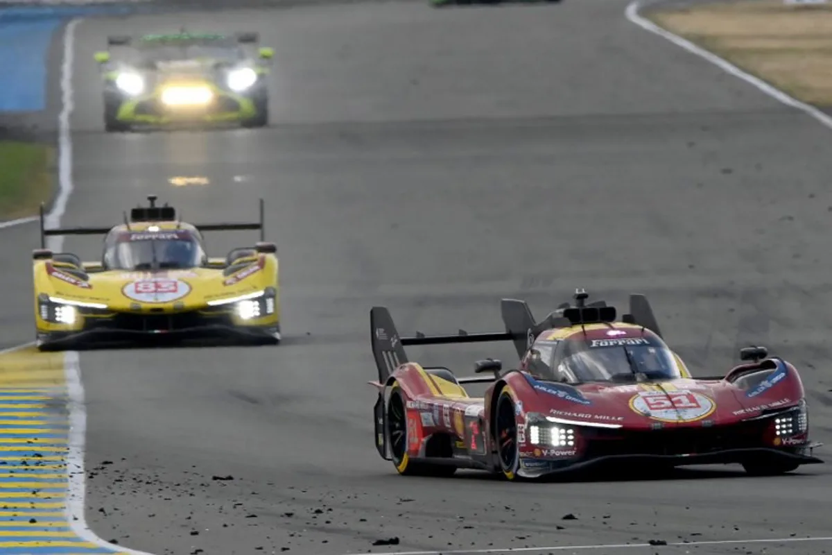 Ferrari AF Corse Thor Team's hypercar #51 Italian driver Antonio Gioninazzi (R) and Ferrari AF Corse Thor Team's hypercar #83 Polish driver Robert Kubica compete in the 24 Hours of Le Mans 2025, at the Le Mans circuit, north-western France, on June 15, 2025. JEAN-FRANCOIS MONIER / AFP