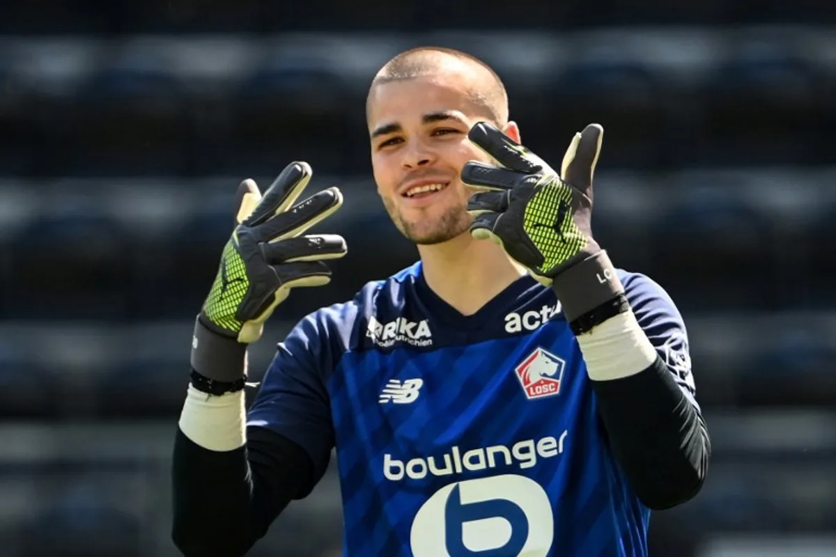 Lille's French goalkeeper #30 Lucas Chevalier gestures during the French L1 football match between SCO Angers and Lille LOSC at The Raymond-Kopa Stadium in Angers, western France on April 27, 2025. JEAN-FRANCOIS MONIER / AFP