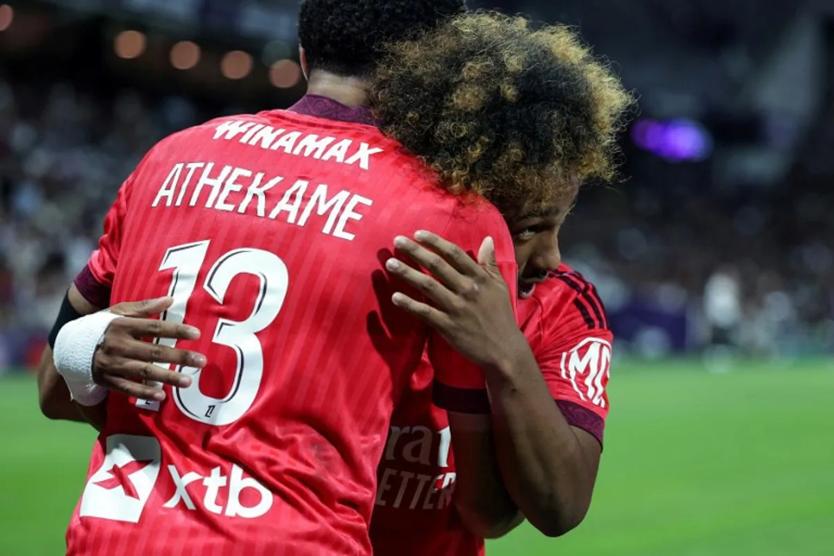 Lyon's Belgian forward #11 Malick Fofana (R) celebrates with Lyon's Swiss defender #13 Zachary Athekame (L) after scoring his team second goal during the French L1 football match between Toulouse Football Club (TFC) and Olympique Lyonnais (OL) at the Stadium in Toulouse, southwestern France, on August 22, 2026. Valentine CHAPUIS / AFP
