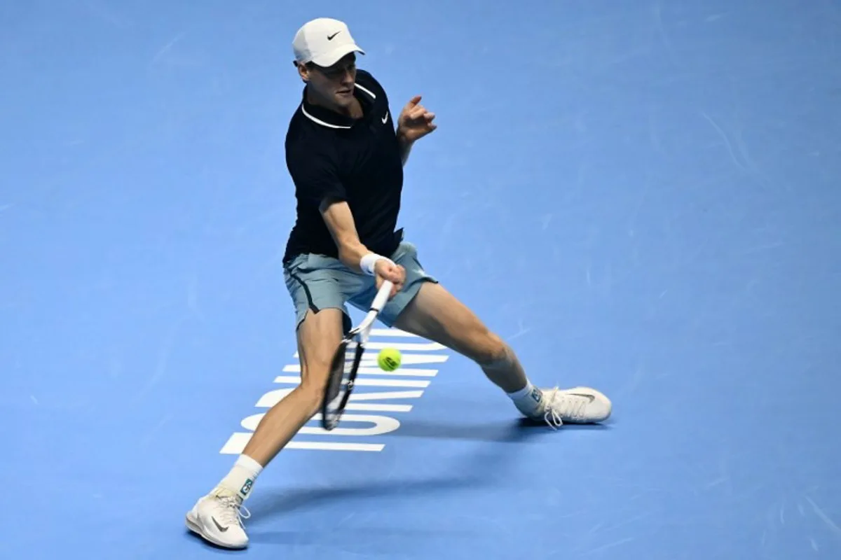 Italy's Jannik Sinner hits a return to USA's Taylor Fritz during their match at the ATP Finals tennis tournament in Turin on November 12, 2024.  Marco BERTORELLO / AFP