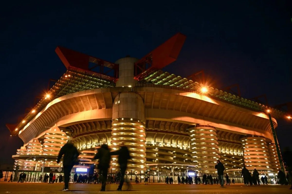 Pedestrians walk by San Siro Stadium prior to the Italian Serie A football match between Inter Milan and Genoa, in Milan on March 4, 2024.  GABRIEL BOUYS / AFP