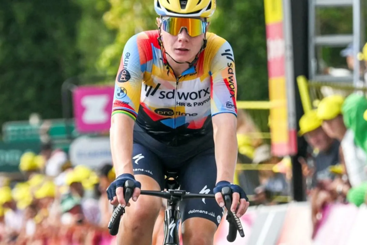 Team SD Worx-Protime's Belgian rider Lotte Kopecky crosses the finish line to finish in second-placed in the 3rd (out of 9) stage of the fifth edition of the Women's Tour de France cycling race, 156.5 km from Geneva to Poligny, in Poligny, central-eastern France on August 3, 2026. NICOLAS TUCAT / AFP