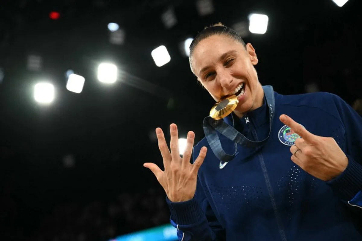 Gold medallists USA's #12 Diana Taurasi poses with her medal after the women's Gold Medal basketball match between France and the USA during the Paris 2024 Olympic Games at the Bercy  Arena in Paris on August 11, 2024.  Paul ELLIS / AFP