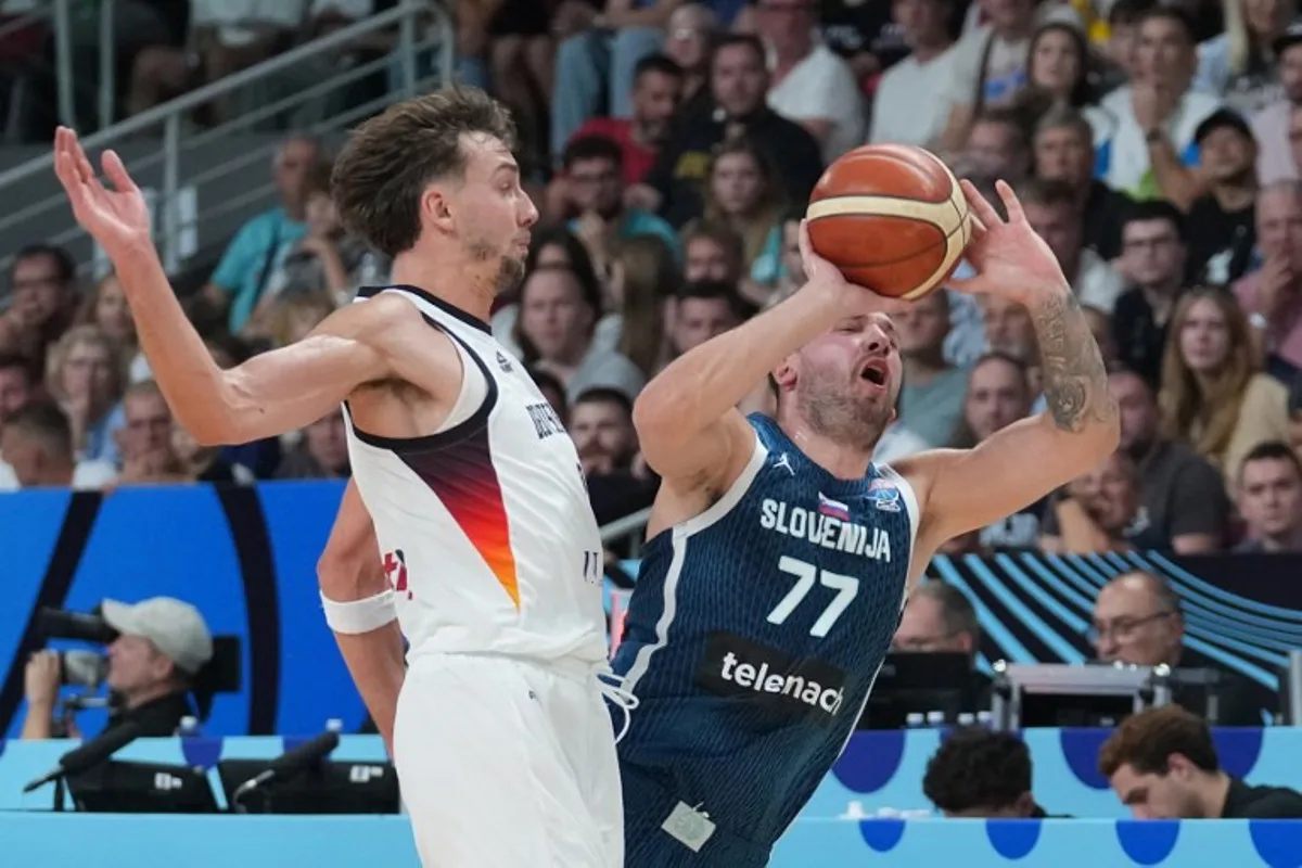 Germany's guard #09 Franz Wagner and Slovenia's guard #77 Luka Doncic vie for the ball during the FIBA EuroBasket 2025 quarter-final basketball match between Germany and Slovenia in Riga, Latvia, on September 10, 2025. Gints Ivuskans / AFP