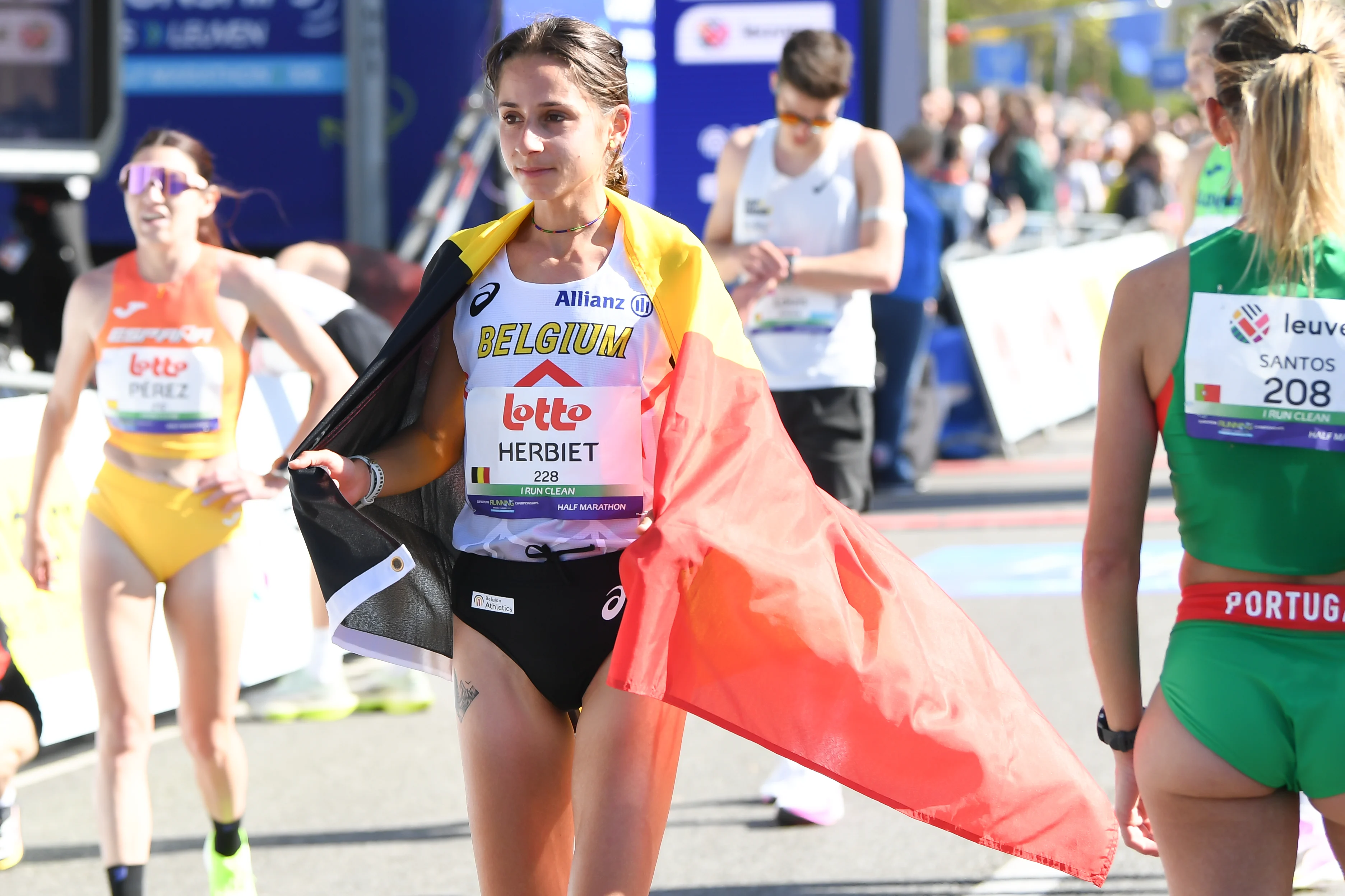 Belgian Chloe Herbiet celebrates after winning the half marathon race at European Running Championships, in Leuven, Saturday 12 April 2025. BELGA PHOTO JILL DELSAUX