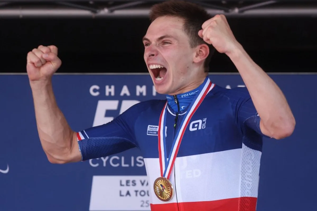 Groupama-FDJ United's French rider Romain Gregoire celebrates on the podium after winning the men's Elite Road Race, part of the French Cycling Championship 2026, near La Tour du Pin, central-eastern France on June 28, 2026.  Alex MARTIN / AFP