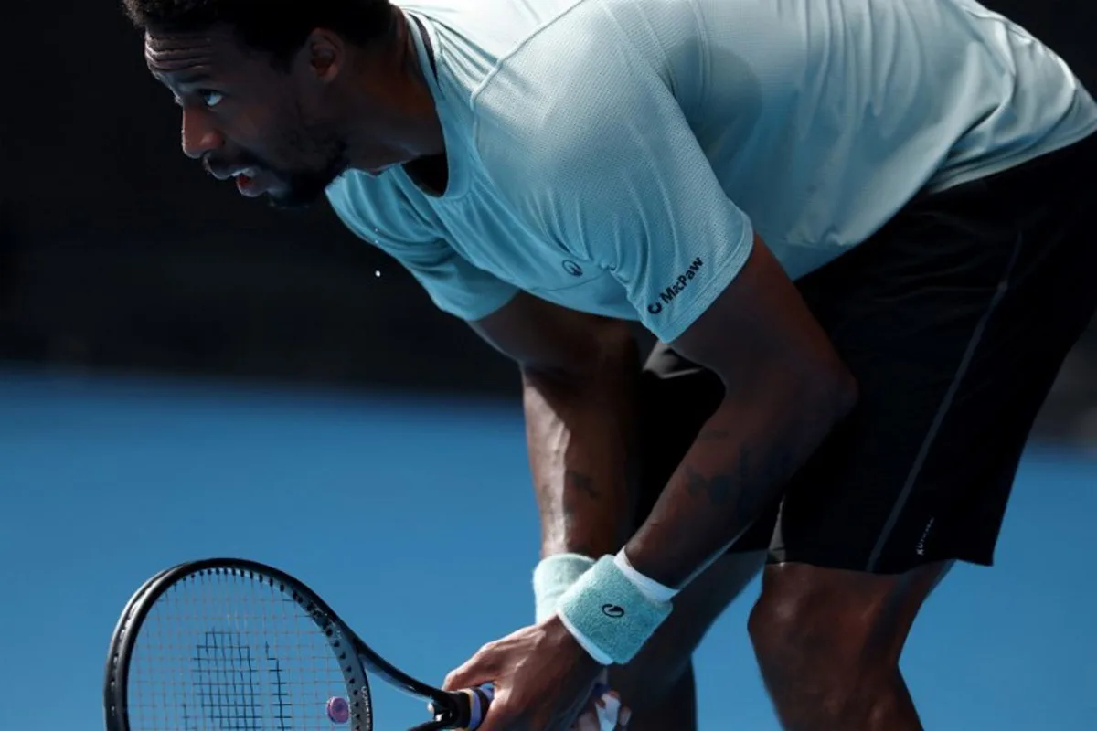 Sweat drips from France's Gael Monfils as he readies himself to receive a serve from the USA's Ben Shelton during their men's singles match on day nine of the Australian Open tennis tournament in Melbourne on January 20, 2025.  DAVID GRAY / AFP