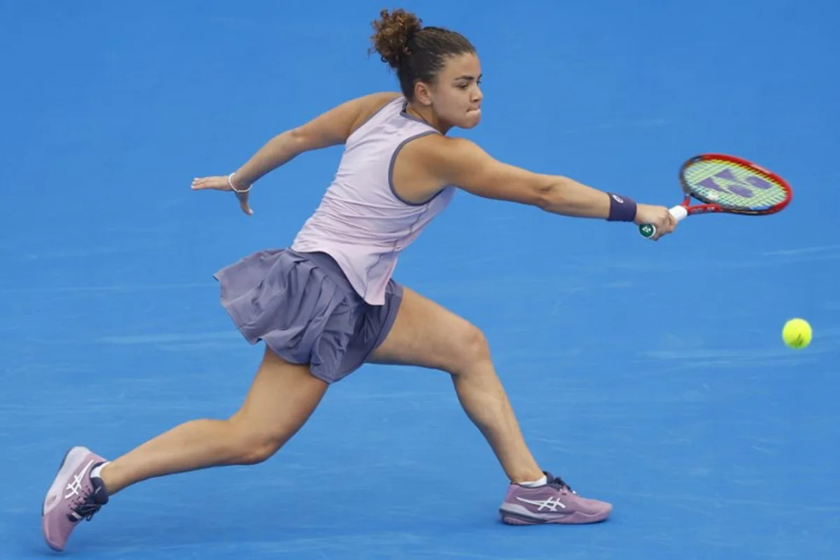 Jasmine Paolini of Italy returns the ball to Jelena Ostapenko of Latvia during their 2025 WTA Qatar Open match at the Khalifa International Tennis Complex in Doha on February 12, 2025.  KARIM JAAFAR / AFP