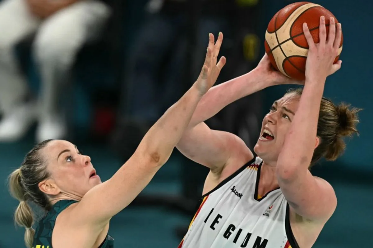 Belgium's #11 Emma Meesseman (R) takes a shot in the women's Bronze Medal basketball match between Belgium and Australia during the Paris 2024 Olympic Games at the Bercy  Arena in Paris on August 11, 2024.  Paul ELLIS / AFP