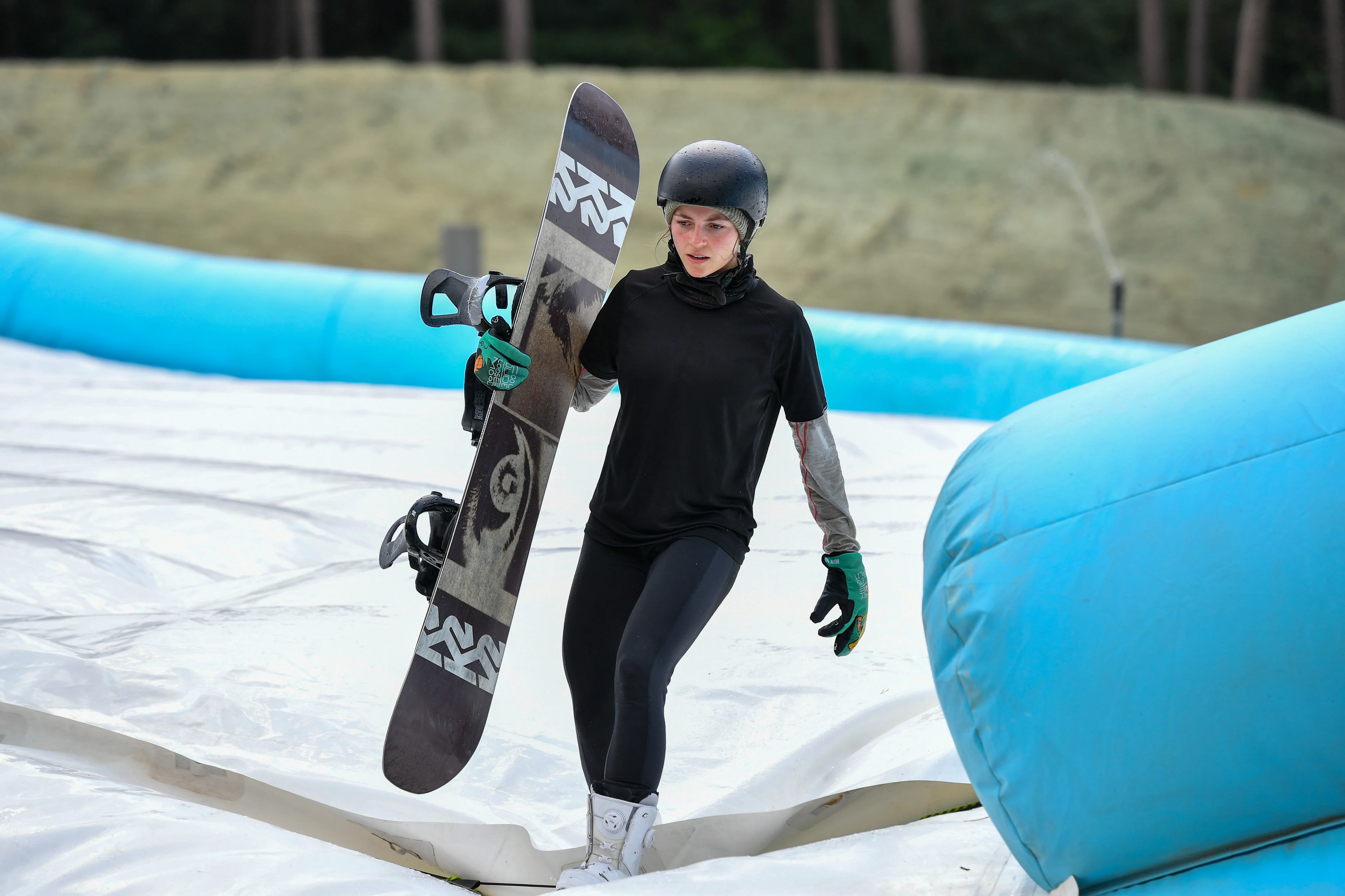 Belgian Snowboarder Loranne Smans pictured in action during the opening of a large dry slope by Flemish minister Weyts, Sport Vlaanderen, the city of Genk and Snow Sports Vlaanderen, in Genk, Saturday 26 June 2021. In a technical sport with very complex movements, the snowboarders and their staff have to look for conditions that allow to perform many repetitions in safe conditions. The dry slope with airbag in Genk makes it possible to train in winter and summer, regardless of the presence of snow. On a track with a height of 34 meters, a length of 62 meters, a slope of 30 degrees and an adjustable 'kicker' (dismount), the riders can imitate every 'Big Air jump' in the world. BELGA PHOTO BERNARD GILLET