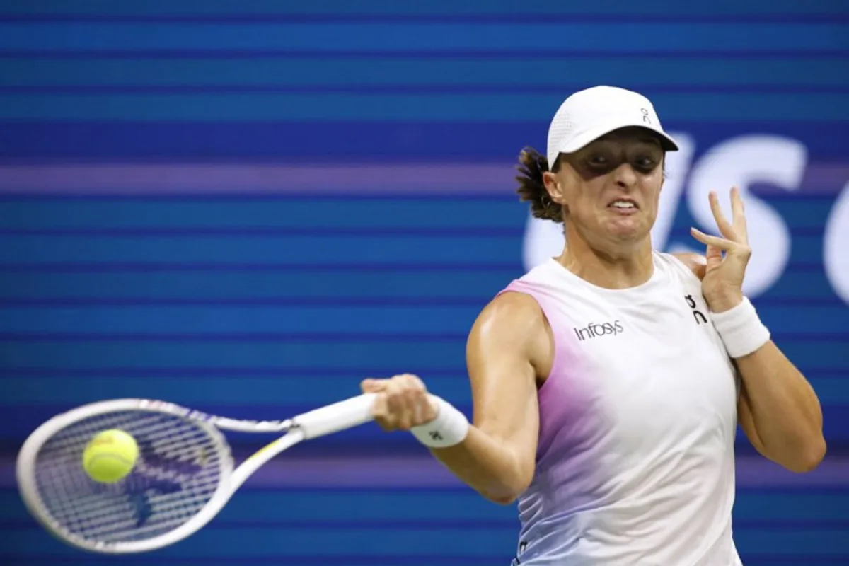 Poland's Iga Swiatek plays a forehand return against USA's Jessica Pegula during their women's quarterfinals match on day ten of the US Open tennis tournament at the USTA Billie Jean King National Tennis Center in New York City, on September 4, 2024.  Kena Betancur / AFP