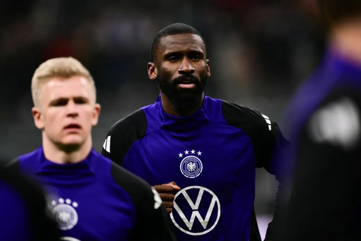 Germany's defender #02 Antonio Rudiger warms up ahead of the Nations League quarter final first leg football match between Italy and Germany at the San Siro Stadium in Milan, on March 20, 2025. Marco BERTORELLO / AFP