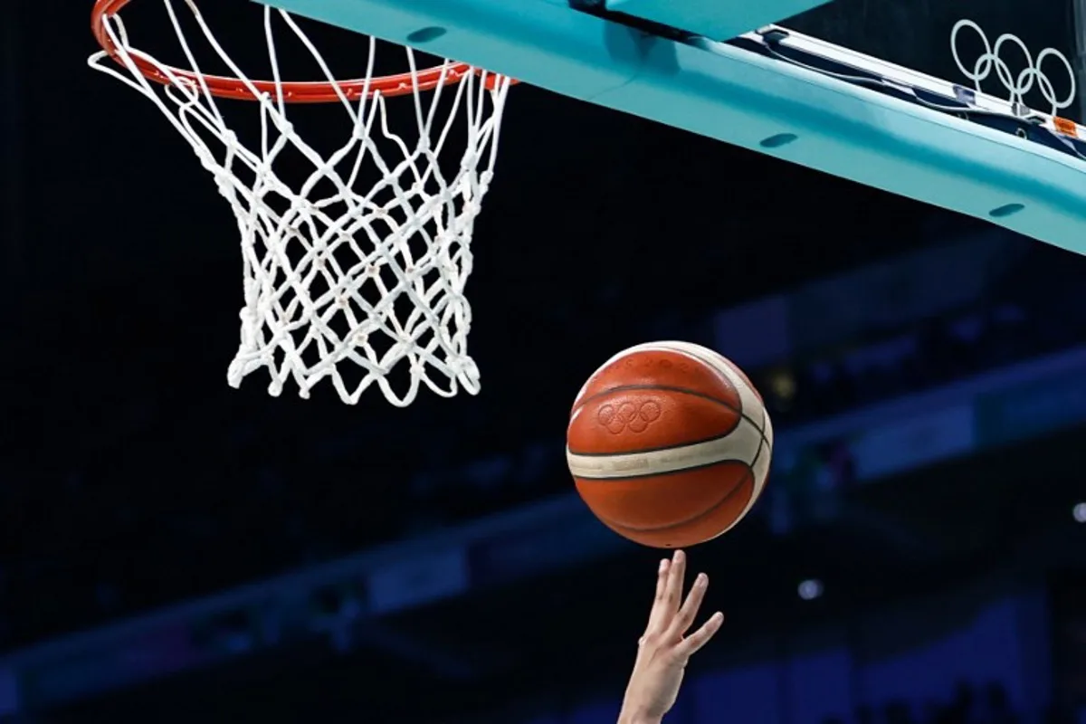 Spain's #12 Maite Cazorla goes to the basket and scores in the women's preliminary round group A basketball match between Serbia and Spain during the Paris 2024 Olympic Games at the Pierre-Mauroy stadium in Villeneuve-d'Ascq, northern France, on August 3, 2024.  Sameer Al-Doumy / AFP