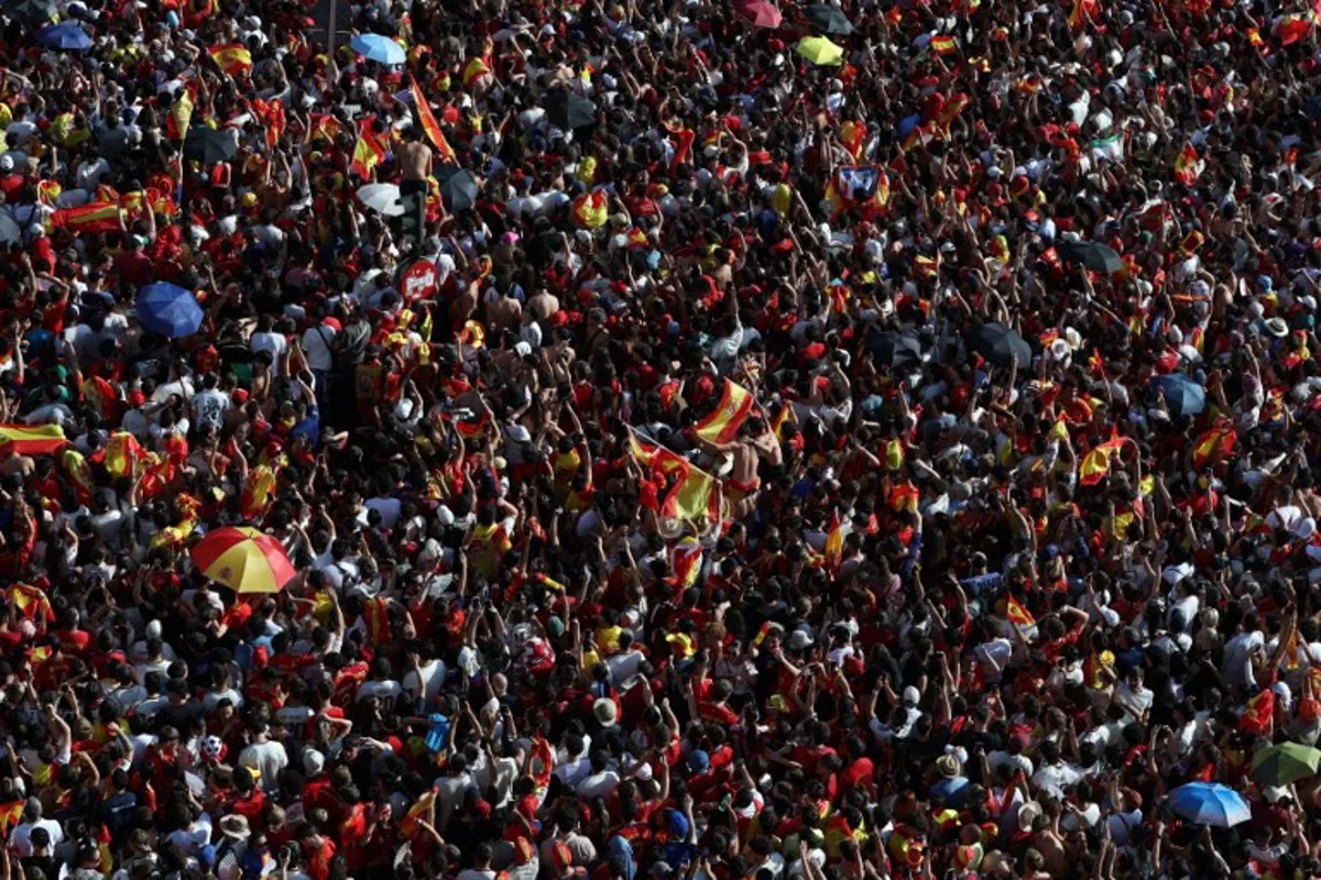 Spain fans pack Cibeles Square in Madrid on July 20, 2026, as they await the arrival of Spain's players one day after the national football team won their second World Cup title following a 1-0 victory against Argentina. Spain's World Cup winners come back home to a heroes' welcome in Madrid, where a million fans are expected to greet them after a night of raucous celebrations across the country. Pierre-Philippe MARCOU / AFP