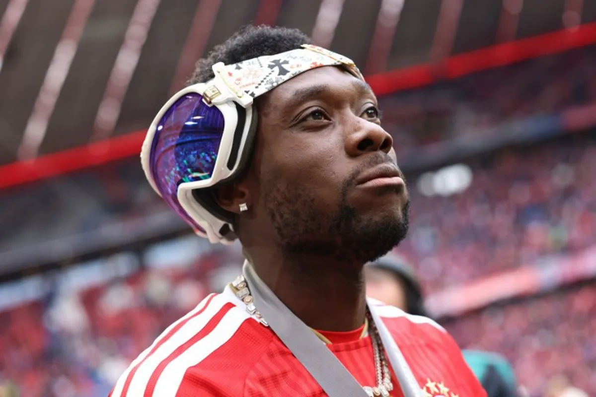Bayern Munich's Canadian defender #19 Alphonso Davies looks on with sunglasses on the back of his head during celebrations for the Bundesliga trophy after the German first division Bundesliga football match between FC Bayern Munich and FC Cologne in Munich, southern Germany, on May 16, 2026. Alexandra BEIER / AFP