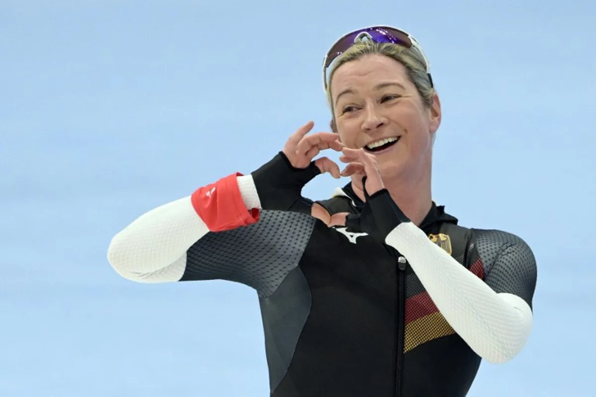 Olympic record holder Germany's Claudia Pechstein gestures after competing in the women's speed skating 3000m event during the Beijing 2022 Winter Olympic Games at the National Speed Skating Oval in Beijing on February 5, 2022.  Sebastien Bozon / AFP