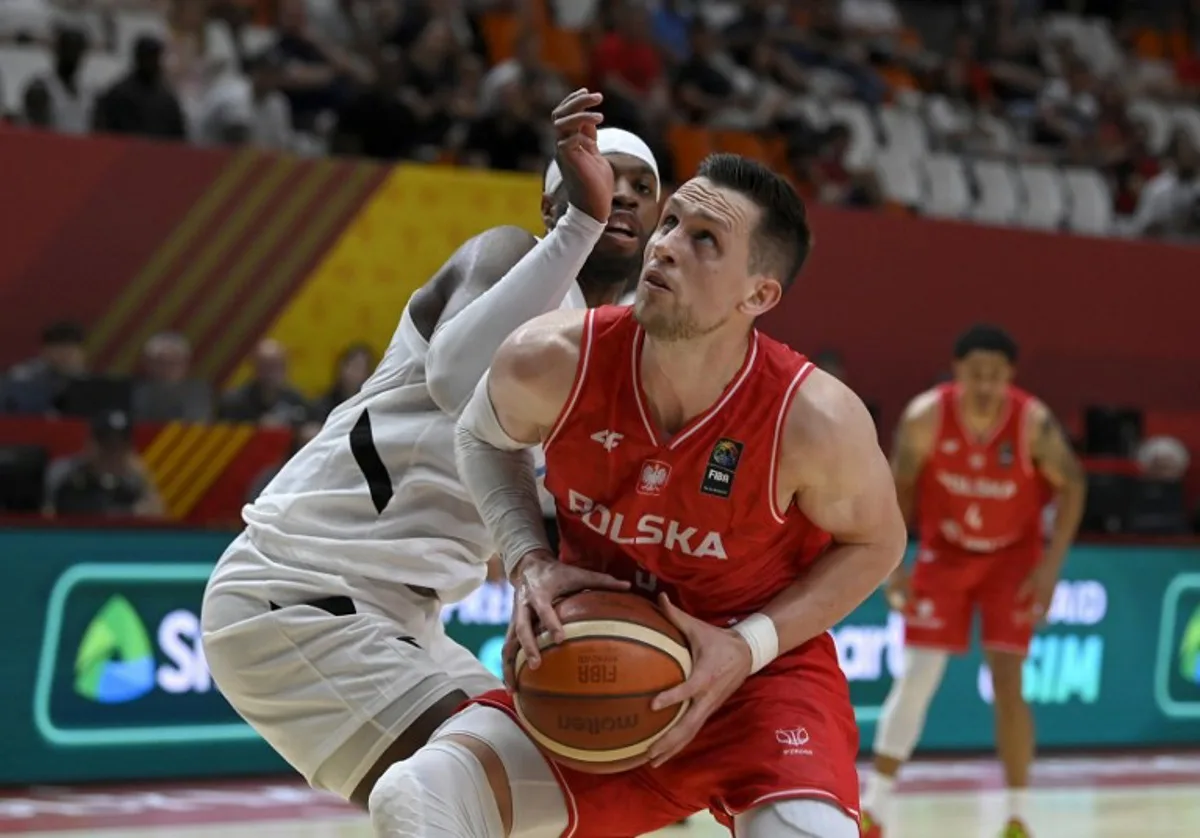 Poland's forward #09 Mateusz Ponitka vies for the ball with Bahamas' guard #07 Buddy Hield during the 2024 FIBA Olympic Qualifying Tournament basketball match between Bahamas and Poland in Valencia, on July 3, 2024. JOSE JORDAN / AFP