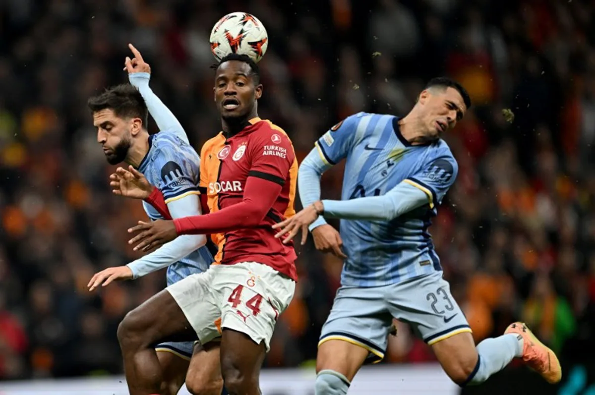 Galatasaray's Belgian forward #44 Michy Batshuayi (C) vies with Tottenham's Uruguayan midfielder #30 Rodrigo Bentancur (L) and Tottenham's Spanish defender #23 Pedro Antonio Porro Sauceda (R)during the UEFA Europa League, League phase - Matchday 4, football match between Galatasaray and Tottenham at the Ali Sami Yen Spor Kompleksi in Istanbul on November 7, 2024.  Ozan KOSE / AFP