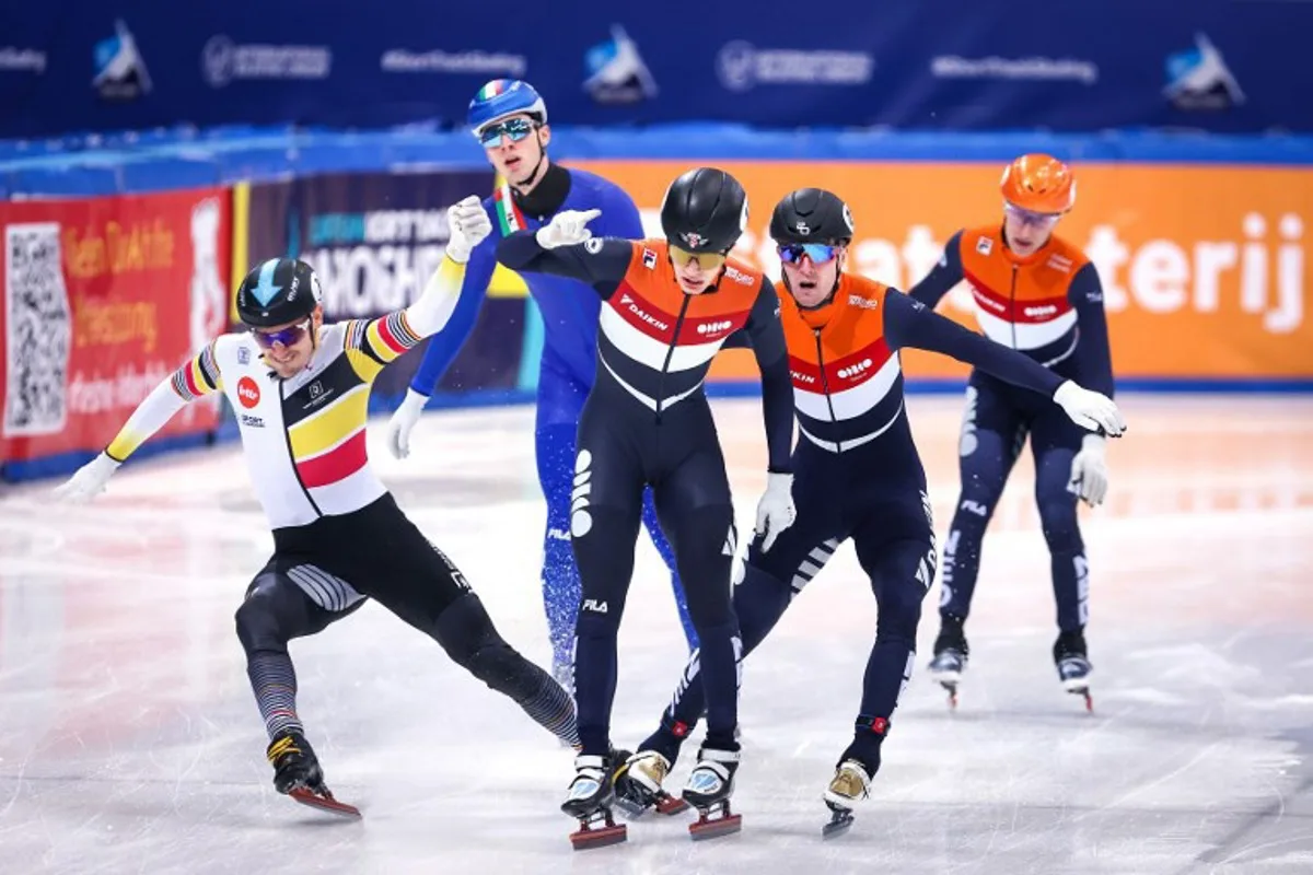 Winner Netherlands's Jens van't Wout #13 (C), second placed Netherlands's Sven Roes #132 (2nd R) and third-placed Belgium's Stijn Desmet #08 (L) cross the finish line of the men's 1500m event on Day 2 of the ISU European short track speed skating Championships in Dresden, eastern Germany, on January 18, 2025.  Ronny HARTMANN / AFP