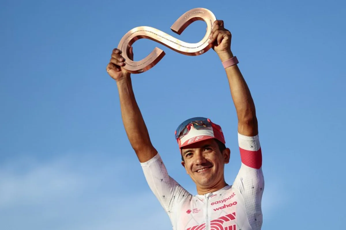 Third placed EasyPost's Ecuadorian rider Richard Carapaz celebrates on the podium after the 21st and last stage of the 108th Giro d'Italia cycling race of 143kms from Rome to Rome on June 1, 2025.  Luca Bettini / AFP