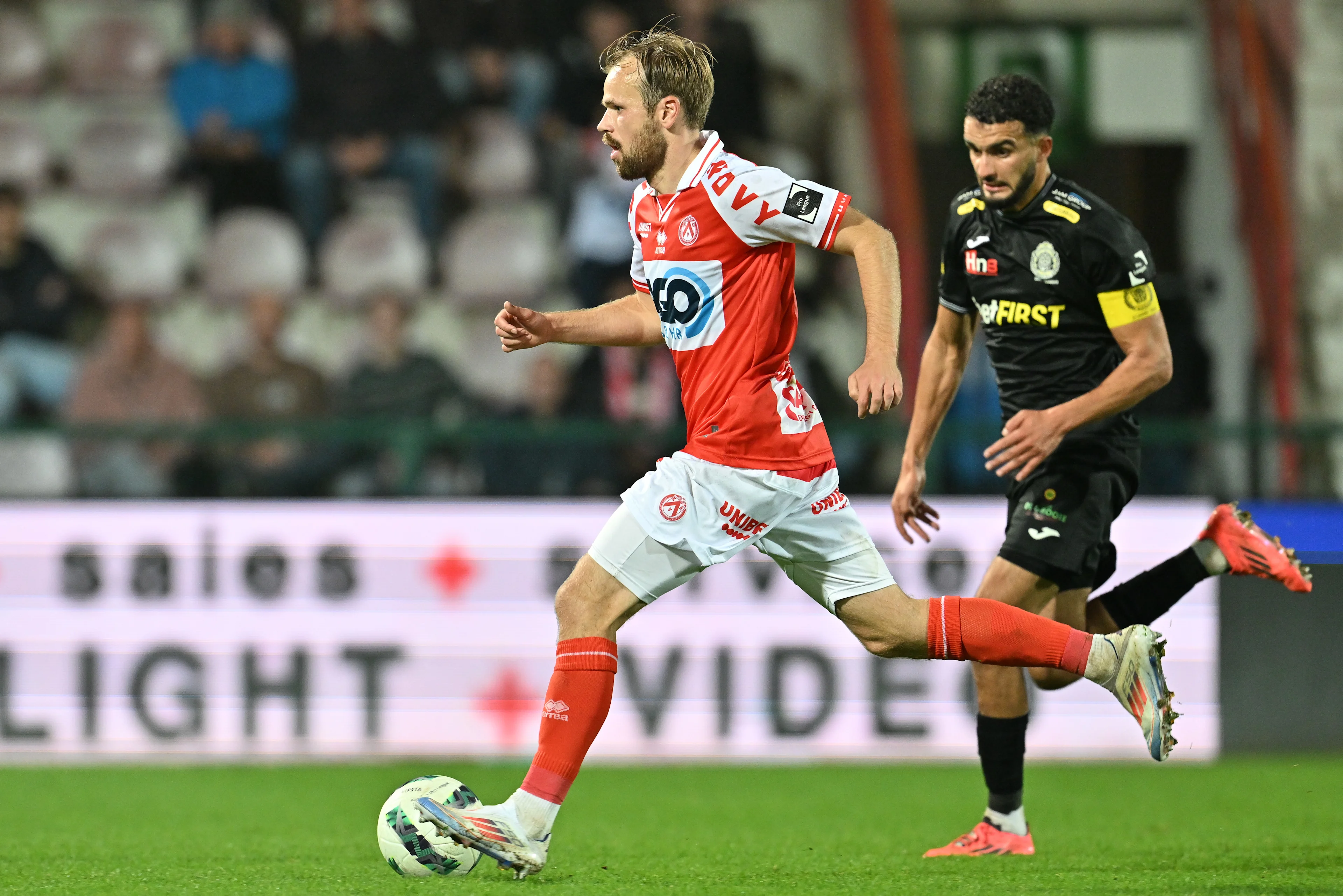 Kortrijk's Iver Fossum and Lokeren's Naim Boujouh pictured in action during a soccer game between JPL club KV Kortrijk and second division club Lokeren-Temse, Wednesday 30 October 2024 in Heule, in the round 1 of 16 of the 'Croky Cup' Belgian soccer cup. BELGA PHOTO DAVID CATRY