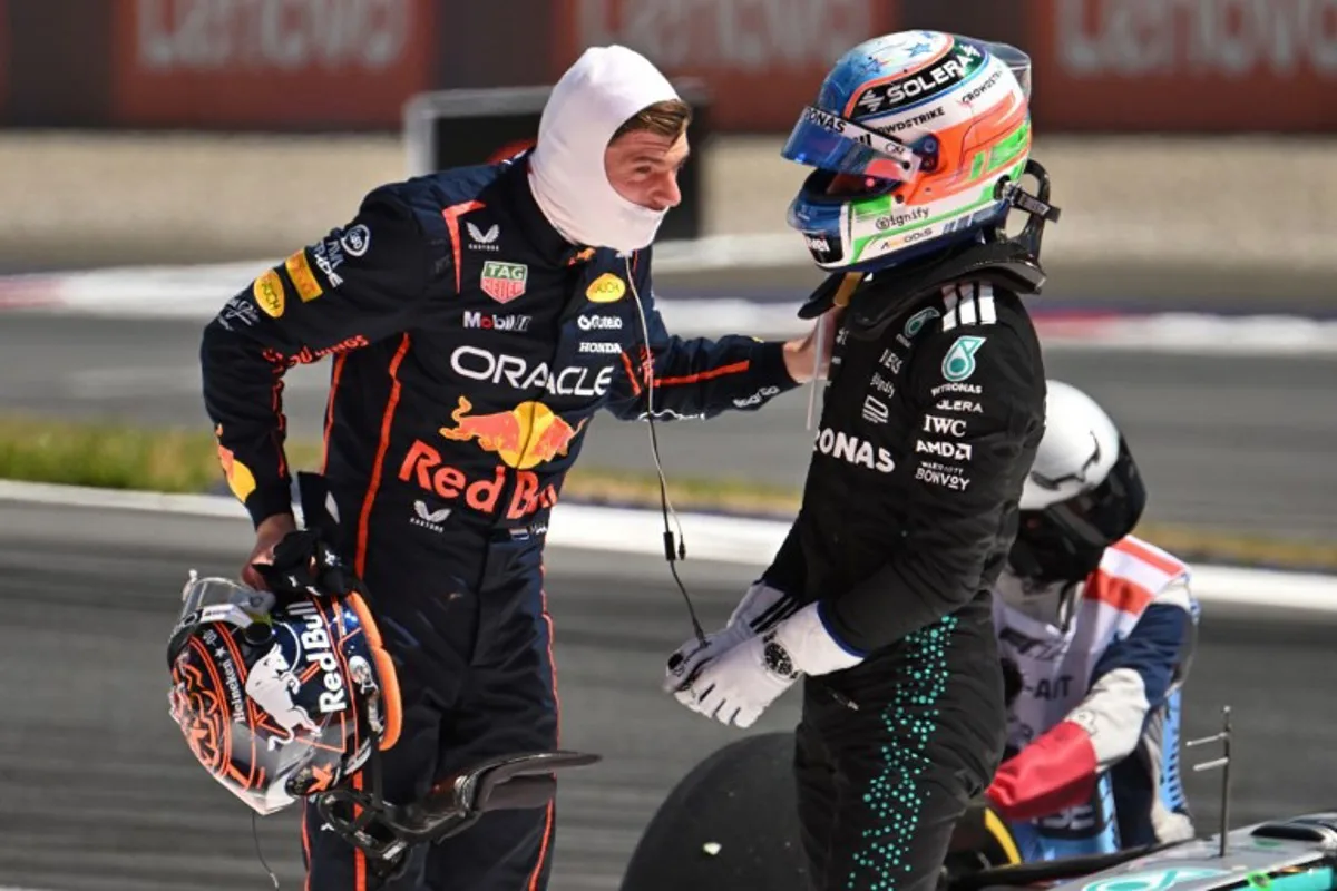 Red Bull's Dutch driver Max Verstappen (L) and Mercedes' Italian driver Kimi Antonelli speak after their cars crashed during the Formula One Austrian Grand Prix at the Red Bull Ring race track in Spielberg, Austria, on June 29, 2025. Jure Makovec / AFP