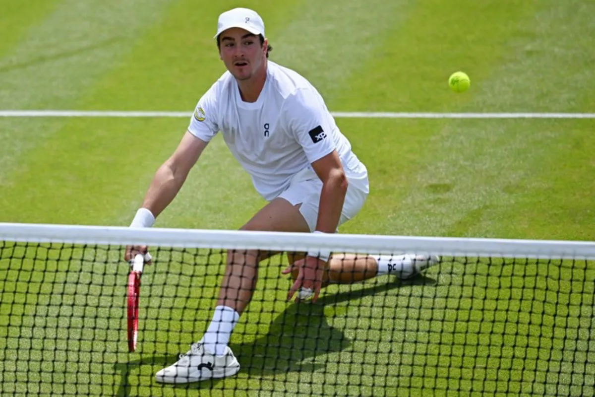 Brazil's Joao Fonseca returns to Russia's Roman Safiullin during their men's singles third round tennis match on the fifth day of the 2026 Wimbledon Championships at The All England Lawn Tennis and Croquet Club in Wimbledon, southwest London, on July 3, 2026.  Kirill KUDRYAVTSEV / AFP